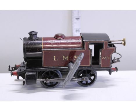 A vintage tin plate O gauge clockwork locomotive 