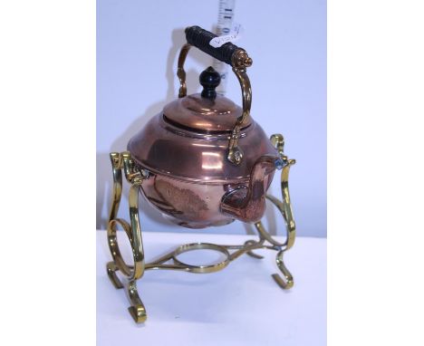 A vintage copper kettle on brass stand 