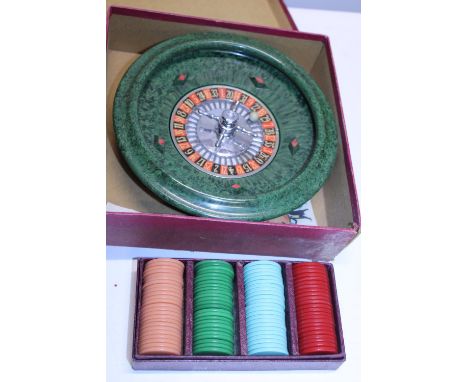 A vintage boxed roulette wheel with chips 