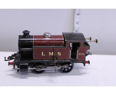 A vintage tin plate O gauge clockwork locomotive 