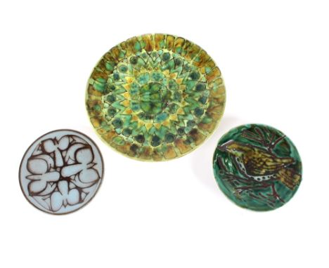 A Poole Studio pottery dish having green stylised decoration, 20cm dia.; a Poole Studio shallow dish decorated with a bird 13