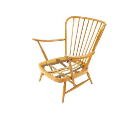 A low light Ercol stick back easy chair, raised on slender rounded tapering supports united by stretcher