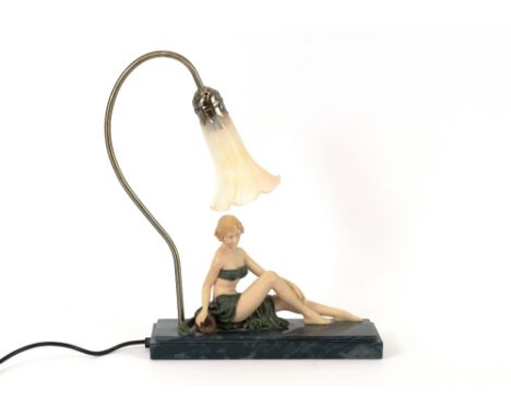 An Art Deco style lamp, in the form of a seated maiden beneath a flower head shaped shade, 43cm high