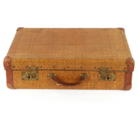 A Vintage wicker work leather and brass mounted suitcase 