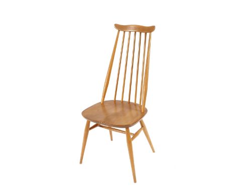 A set of four light Ercol stick back dining chairs 