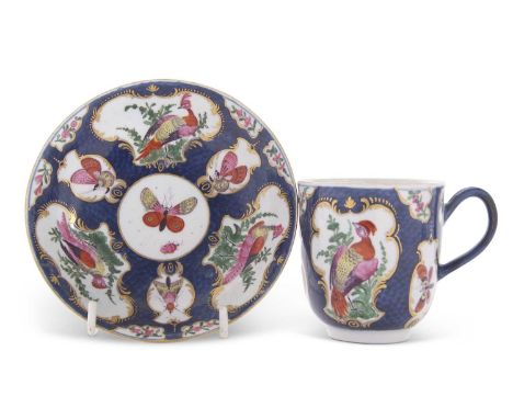An 18th Century Worcester porcelain cup and saucer, the scale blue ground with reserves, painted with birds and insects, Worc