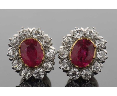 A pair of ruby and diamond cluster earstuds, the oval rubies in rubover mounts and surrounded by round old mine and European 