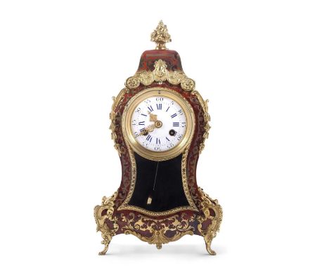 A 20th Century boulle type mantel clock with circular dial with Roman and Arabic numerals over a glazed section, the brass mo