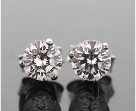 A pair of diamond earstuds, the round brilliant cut diamonds, estimated approx. 0.63cts each (1.26cts gross), in a three claw