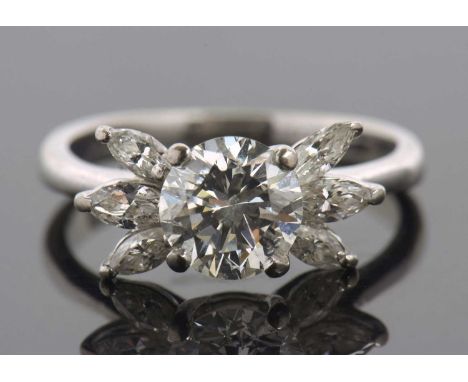 A diamond cluster ring, the central round brilliant cut diamond, estimated approx. 1.66cts, in a four claw mount and set to e