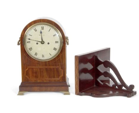 McCabe - A Georgian mahogany cased bracket clock set in an arched case inlaid decoration, brass side carrying handles and gri