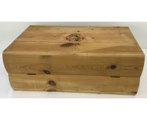 A vintage pine wine bottle box in the shape of two books.