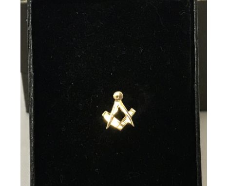 A 9ct gold Masonic set square and compass shaped tie pin.