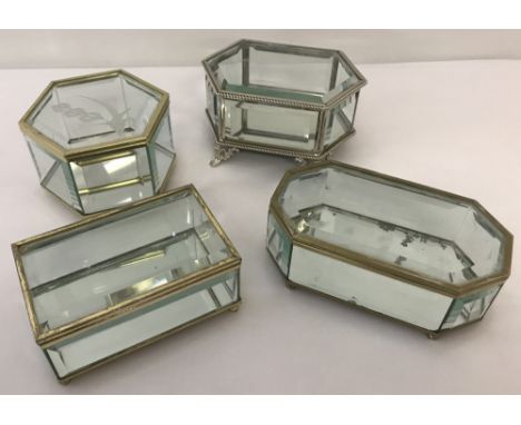 Three glass and brass mirror based trinket boxes with bun feet. Together with a glass and white metal mirrored base trinket b