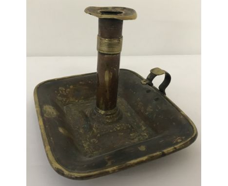 A vintage brass portable candle stick holder.