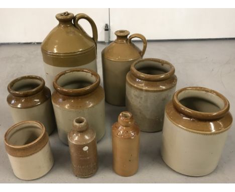 Four vintage stone bottles together with five stone jars. To include Batey and R White.