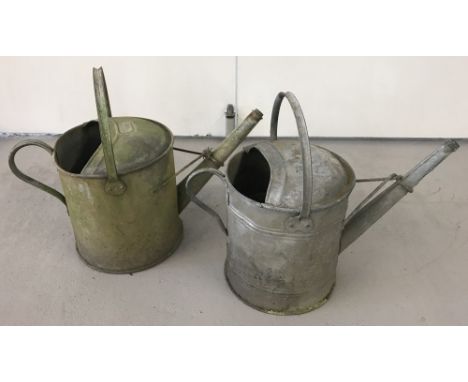 Two vintage 1.5 gallon galvanized metal watering cans.