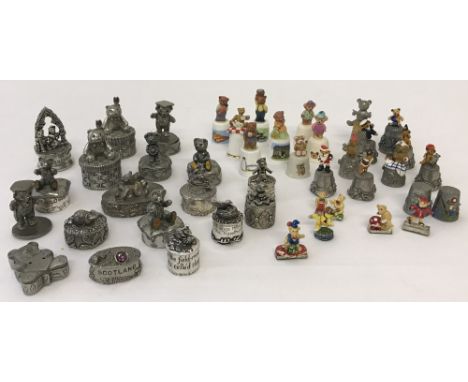 A collection of teddy bear related ceramic and pewter thimbles. Together with pewter and white metal  teddy bear miniature tr