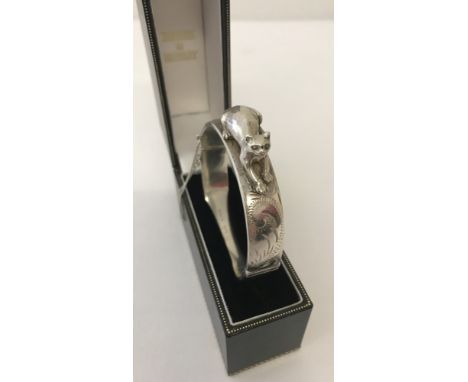 A vintage hinged cat bangle with Half engraved design. Complete with safety chain. Hallmarked Birmingham 1974.