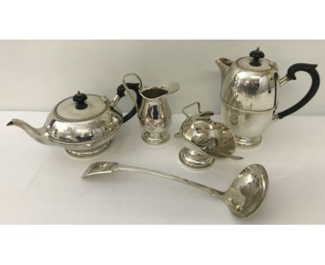 A vintage 4 piece silver plated tea set together with a ladle and a jam spoon. Tea set with engraved floral swag detail and b