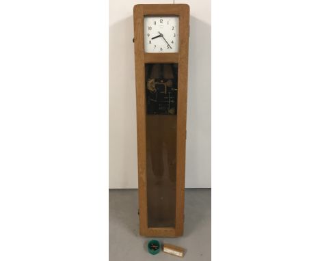 A wall mounted oak cased, glass fronted Master clock by Synchronome, London. Made in England. This clock was used in factorie