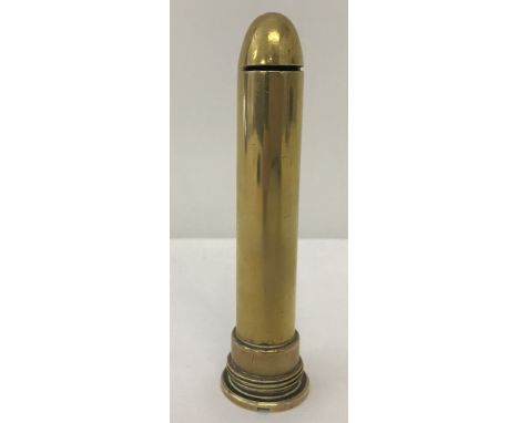 A vintage trench art money box made from a shell case. Base unscrews.