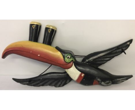 A large vintage wall hanging Guinness Toucan display, possibly 1950's/60's. Carrying 2 pints of Guinness on his beak. Some mi