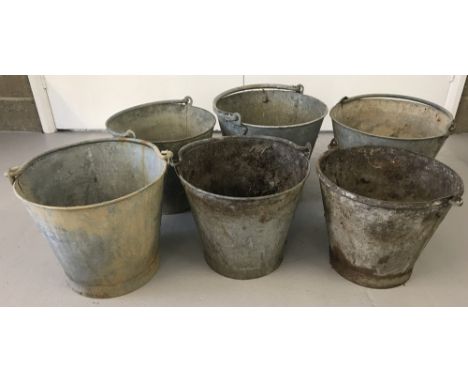 Six vintage galvanized metal buckets with handles, in differing sizes and conditions.