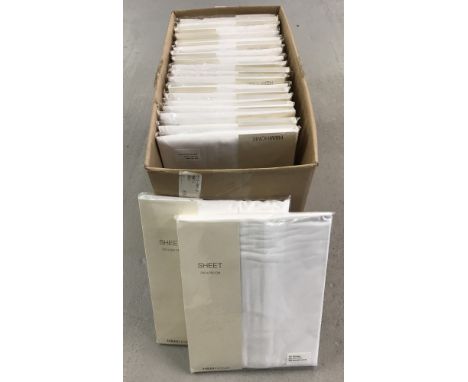 A box of 20 new, packaged and unopened white cotton double flat bed sheets. Made for H &amp; M Home.