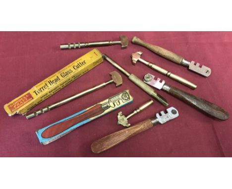 A small tray of vintage glass cutters to include early brass examples.