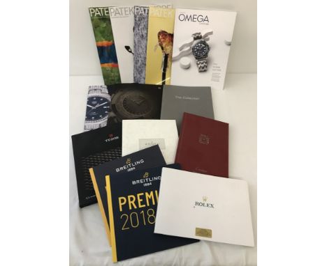 A collection of 14 watch catalogues. To include Breitling, Patek Philippe, Rolex and Tag Heuer.