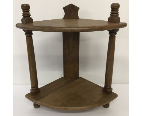 A small wooden corner display shelf with turned detail to upright supports.