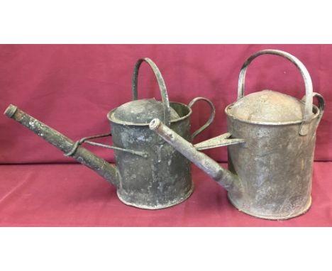 Two vintage galvanized one gallon watering cans.
