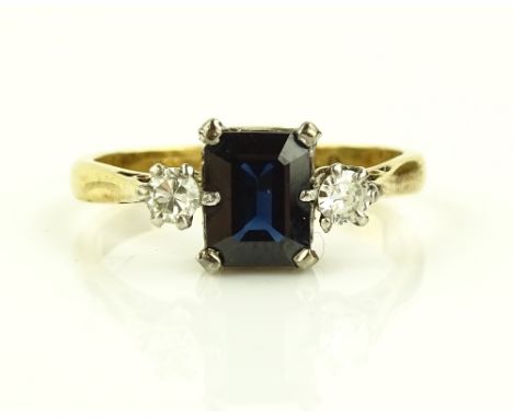 An 18ct gold and platinum 3 stone sapphire and diamond set ring, emerald cut sapphire approx. 1.17cts, setting height 8mm, si