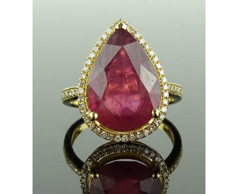 A 14ct gold ruby and diamond cluster ring, ruby approx. 8.1cts, total diamond content approx. 0.45cts, setting height 19.2mm,