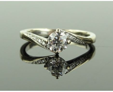 An 18ct white gold solitaire diamond ring, twisted diamond set shoulders, central stone approx. 0.5cts, colour E, clarity VS1