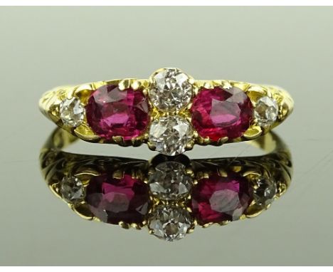 An 18ct gold 6 stone ruby and diamond set ring, scroll engraved bridge, total ruby content 1.02 cts, total diamond content ap