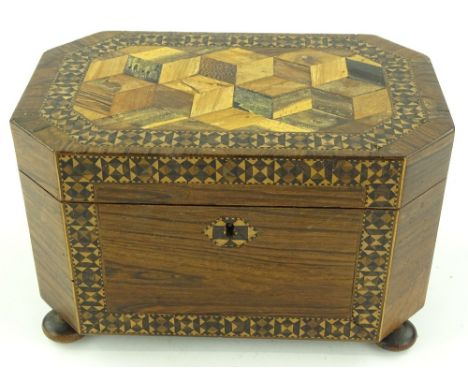 A 19th century Tunbridgeware tea caddy, cube parquetry decorated lid resting on bun feet, with inner lids, width 21.5cm.