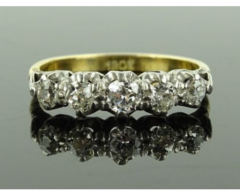An 18ct gold 5 stone diamond half hoop ring, central diamond approx. 0.22cts, setting height 5.2mm, size R, 3.2g.