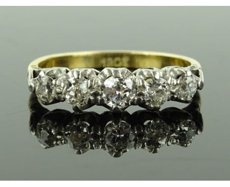 An 18ct gold 5 stone diamond half hoop ring, central diamond approx. 0.22cts, setting height 5.2mm, size R, 3.2g.