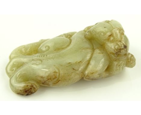 A Chinese carved jade reclinin mythical beast, length 10cm.