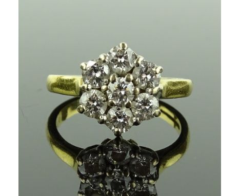 An 18ct gold 7 stone diamond cluster ring, total diamond content approx. 0.96cts, size K, 3.7g.