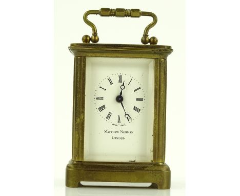 A Michael Norman of London brass cased miniature carriage clock, height 6cm, boxed with papers.