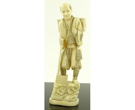 A Japanese Meiji period marine ivory carving, man carrying an axe, signed, height 24cm.