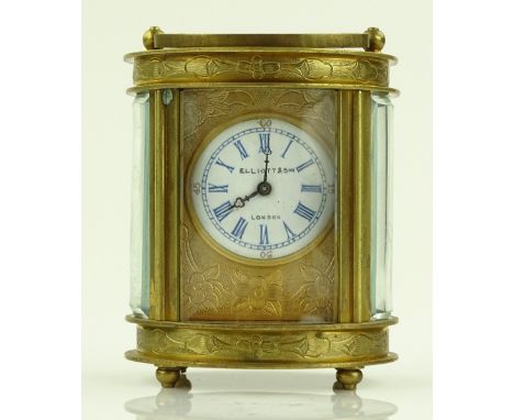 An engraved brass cased oval 8-day carriage clock by Elliott of London, height 8cm.