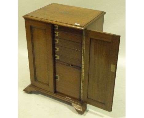 A Victorian light oak 2-door silver cupboard with panelled doors enclosing drawers on bracket feet, width 22", height 2'7".