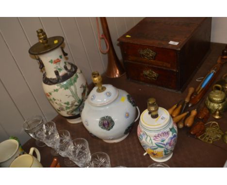 An oriental table lamp base decorated with exotic birds; together with a Poole pottery lamp; and a Denby lamp