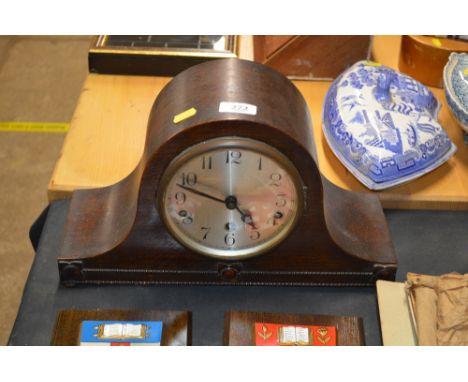 An oak cased three hole mantel clock