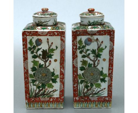 A pair of Chinese vases and covers of square tapering form, decorate with flowers and birds amongst foliage, 27cms high (2).C
