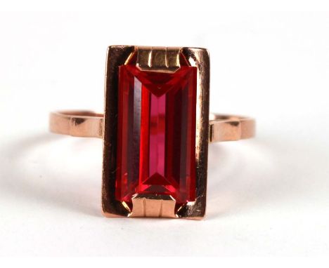 A 14ct gold cocktail ring with emerald cut synthetic ruby, approx UK size 'V'.